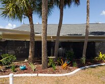 2026_TLC_OfficeUpgrade_P1-8 Imaging, a row of nice bushes framing the fence background. Still more plants in our VHL future.